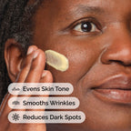 Close-up of a person applying 's yellow Retinal 0.2% Emulsion to their cheek. Text overlays highlight the product's benefits: Evens Skin Tone, Smooths Wrinkles, and Reduces Dark Spots.